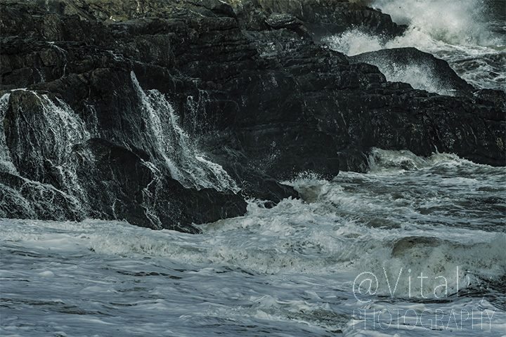 Sea waves breaks over rocks of Greystones Cove. Irish scenery photography.